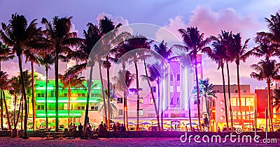 Miami Beach Ocean Drive hotels and restaurants at sunset. City skyline with palm trees at night. Art deco nightlife on Stock Photo