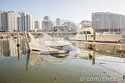 Miami, Florida - September 16, 2017: Sunken boat on Brickell Bay avenue marina days after hurricane Irma strikes the city during Editorial Stock Photo