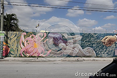 A woman entangled in strings graffiti painted on a wall in Miami. Editorial Stock Photo