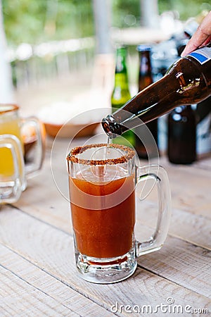 Michelada mexican beer with tomato juice, hot sauce and lemon, Mexican cocktail drink in Mexico Stock Photo