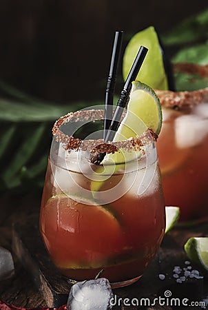 Michelada - Mexican inspired bloody mary alcoholic cocktail with beer, lime juice, tomato juice, spicy sauce and spices, copy Stock Photo