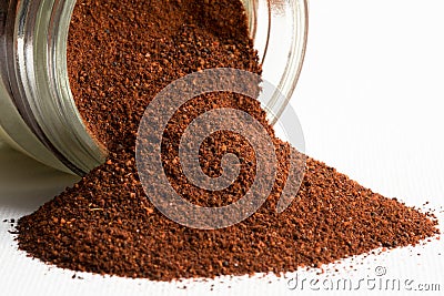 Ground Cloves Spilled from a Spice Jar Stock Photo