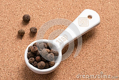 Whole Allspice Spilled from a Teaspoon Stock Photo