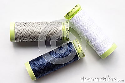 Blue, Grey, and White Sewing Thread Stock Photo