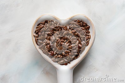 Brown Flaxseeds in a Heart Shape Spoon Stock Photo