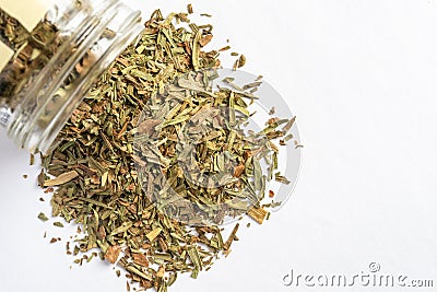 Dried Tarragon Spilled from a Spice Jar Stock Photo