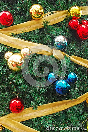 Mickey mouse shaped ornaments as Christmas Tree Decoration with gold golden ribbon Stock Photo