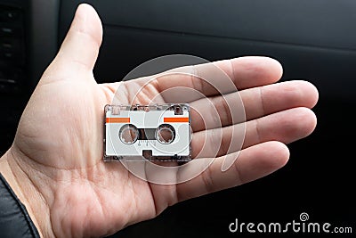 Micro audio cassette on hand background cut Stock Photo