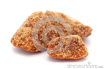 Micro close-up and details of Organic Indian sugarcane jaggery piece gud Saccharum officinarum isolated over white background Stock Photo