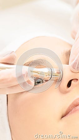 Micro dermbration cosmetology treatment. Facial diamond peeling. Anti acne procedure. Woman and doctor hands. Medical hadware Stock Photo