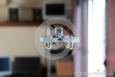 Micro spy drone flying inside a house. Remote controlled nano air vehicle with a small camera Stock Photo