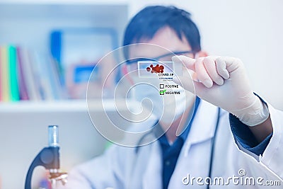 Microbiologist with atube of biological sample contaminated by Coronavirus with label Covid-19,Sample of Covid-19 infectious disea Stock Photo