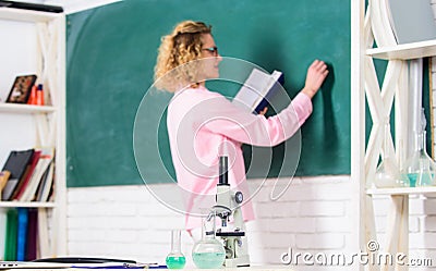 Microbiology and bioengineering. Microscope ant tubes with chemical liquids on table school biology teacher selective Stock Photo