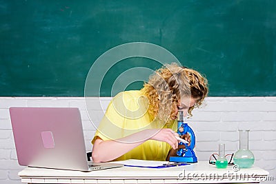 Microbiology concept. Student girl with laptop and microscope. Molecular biology PhD projects. Scientist microbiology Stock Photo