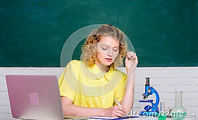 Microbiology concept. Student girl with laptop and microscope. Molecular biology PhD projects. Scientist microbiology Stock Photo