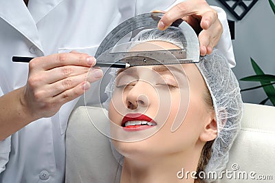 Microblading. Permanent makeup. Attractive woman getting facial care and tattoo Stock Photo