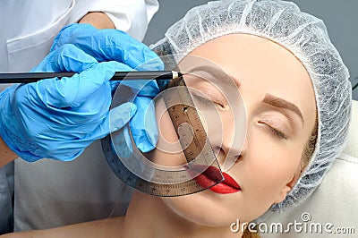 Microblading. Permanent makeup. Attractive woman getting facial care and tattoo Stock Photo