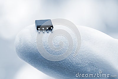 Microchip on a fingertip Stock Photo