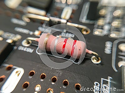 The microcircuit with transistors, resistors, capacitors, coils, contacts on an electronic board in an enlarged form Stock Photo