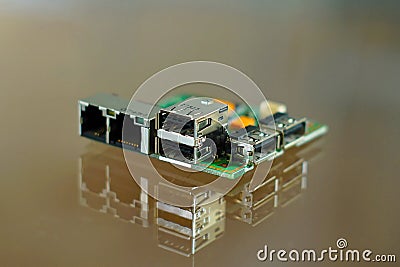 Microcomputer board - electronic components mounted on PCB - printed circuit board with network, phone and USB sockets Stock Photo