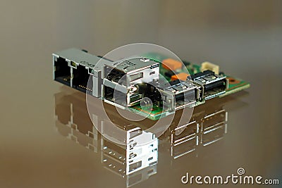 Microcomputer board - electronic components mounted on PCB - printed circuit board with network, phone and USB sockets Stock Photo