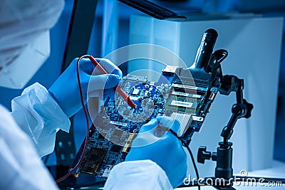 Microelectronics engineer works in a modern scientific laboratory on computing systems and microprocessors. Electronic Stock Photo