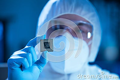 Microelectronics engineer works in a modern scientific laboratory on computing systems and microprocessors. Electronic Stock Photo