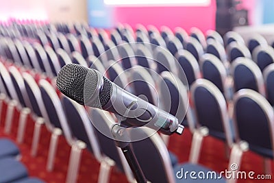 Microphone on the background of rows of chairs in the hall Stock Photo