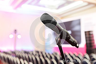 Microphone on the background of rows of chairs in the hall Stock Photo