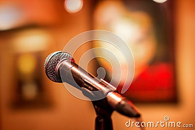 Microphone at a concert with a background in the form of pictures. Stage for performers with microphone stand for voice Stock Photo