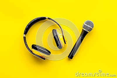 Microphone, headphones for blogger, journalist or musician work on yellow background top view Stock Photo