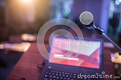 Microphone and laptop computer at podium on business seminar in conference room Stock Photo