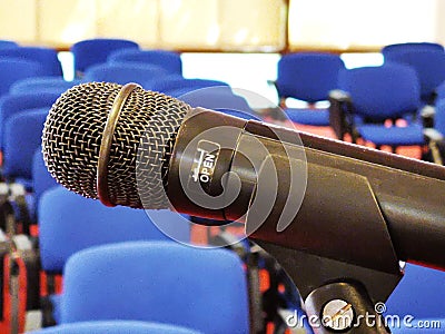 Microphone macro view and chairs in the background Stock Photo