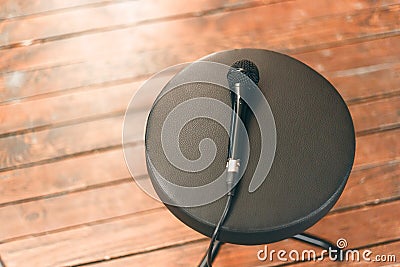 Microphone on a round black chair Stock Photo