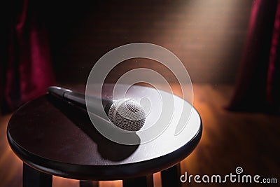 Microphone on a wood stool on a stage Stock Photo