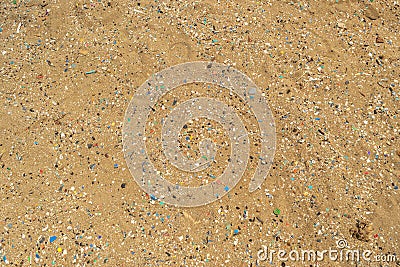 Microplastics on Sand Beach Stock Photo