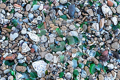 Microplastics on Sand Beach. Micro Plastics Garbage, Tiny Trash Pieces, Microplastic Waste, Dirty Shore Stock Photo