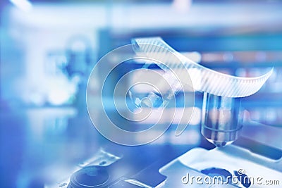 microscope in blue science medical technology laboratory background Stock Photo