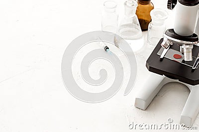 Microscope medical reserch. Blood sample for analysis. White table copy space Stock Photo