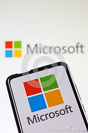 Microsoft logo of the software company on a mobile phone and computer screen Editorial Stock Photo