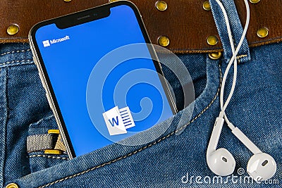 Microsoft word application icon on Apple iPhone X screen close-up in jeans pocket. Microsoft office word icon. Microsoft office on Editorial Stock Photo