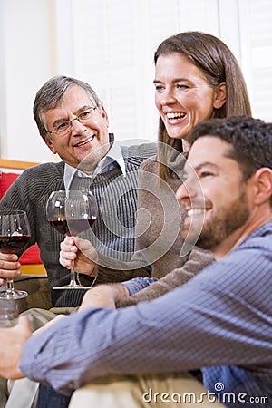 Mid-adult couple and senior parent drinking wine Stock Photo