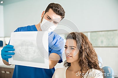 Dentist Showing Xray To Woman At Dental Clinic Stock Photo