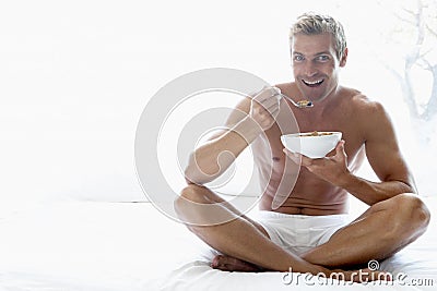 Mid Adult Man Eating A Bowl Of Cereal Stock Photo