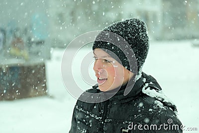 Mid age boy wearing winter hat looking surprised Stock Photo
