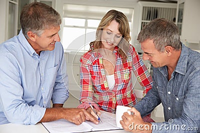 Mid age couple with financial advisor Stock Photo