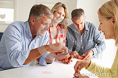 Mid age couples clay modeling together Stock Photo