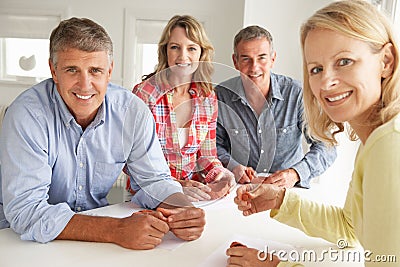 Mid age couples at home clay modelling Stock Photo