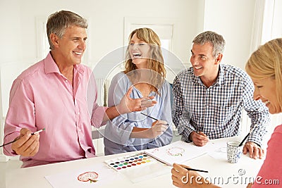 Mid age couples painting with watercolors Stock Photo