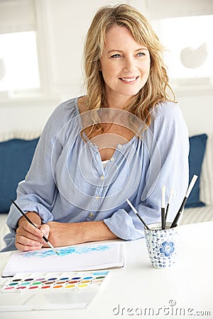 Mid age woman painting with watercolors Stock Photo